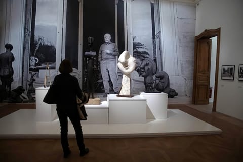 Visitors examine the artworks in the Picasso National Museum